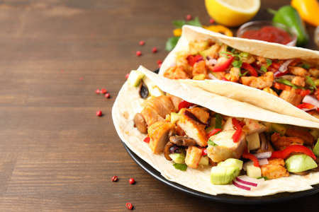 Concept of tasty food with taco on wooden backgroundの写真素材