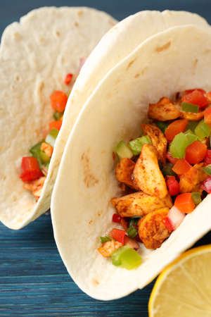 Concept of tasty food with taco on wooden backgroundの写真素材