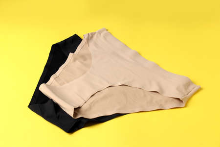 Concept of women's clothes with panties on yellow backgroundの写真素材