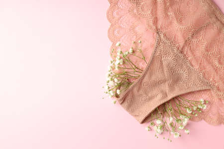 Concept of women's clothes with panties on pink backgroundの写真素材