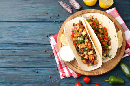 Concept of tasty food with taco on wooden backgroundの写真素材