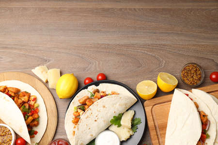 Concept of tasty food with taco on wooden backgroundの写真素材