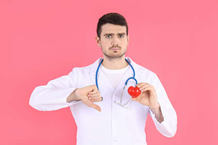 Doctor - intern with heart on pink backgroundの写真素材