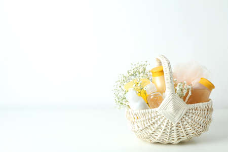 Gift basket with cosmetics on white tableの写真素材