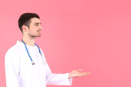 Doctor - intern with stethoscope on pink backgroundの写真素材