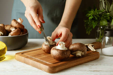 Concept of cooking with champignon on white wooden tableの写真素材