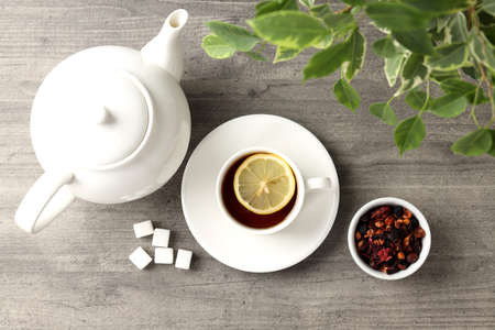 Concept of hot drink with tea on gray wooden backgroundの写真素材