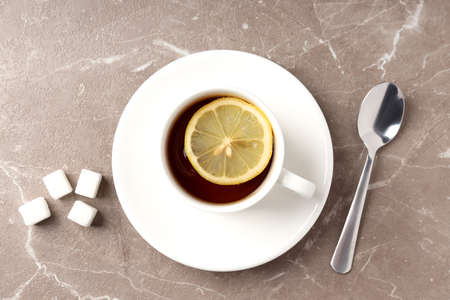 Concept of hot drink with tea on beige textured backgroundの写真素材