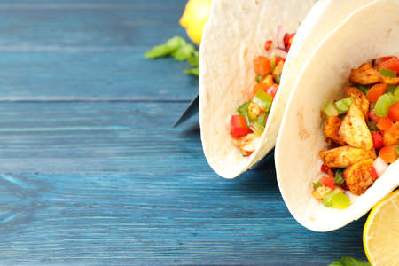 Concept of tasty food with taco on wooden backgroundの写真素材