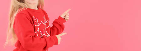 Little girl in Christmas sweater, space for text