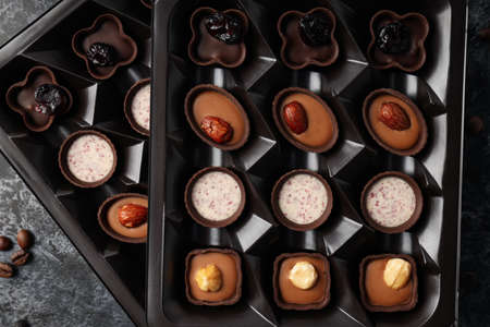 Concept of sweets with chocolate candies on dark textured backgroundの写真素材