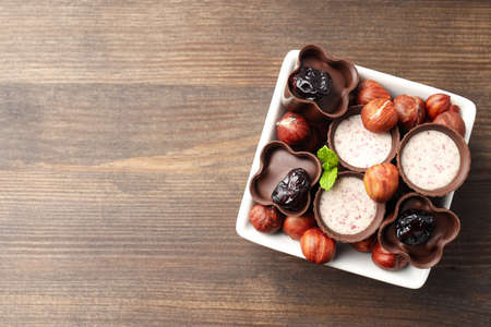Concept of sweets with chocolate candies on wooden backgroundの写真素材