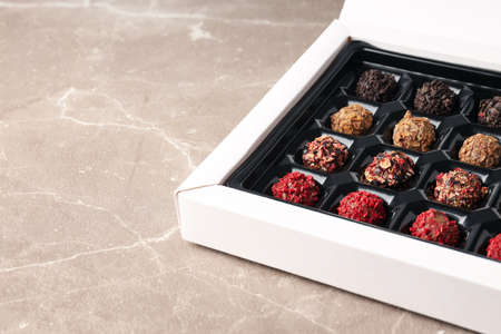 Concept of sweets with chocolate candies on textured backgroundの写真素材