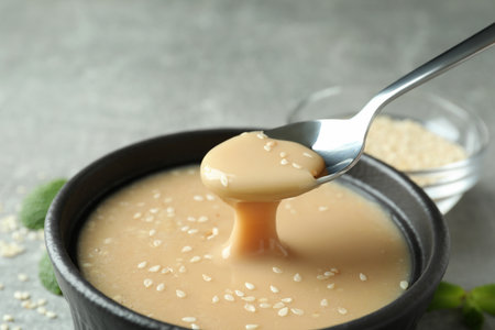 Concept of tasty food with tahini sauce on textured backgroundの写真素材