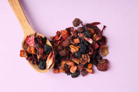 Spoon of fruit tea on purple background, top viewの写真素材