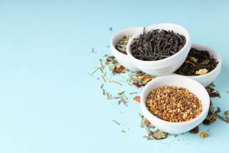 Concept of cooking tea with different types of tea on blue backgroundの写真素材