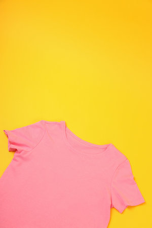 Blank pink t-shirt with space for print on yellow backgroundの写真素材