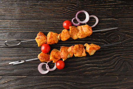 Concept of tasty food with chicken shashlik on dark wooden backgroundの写真素材