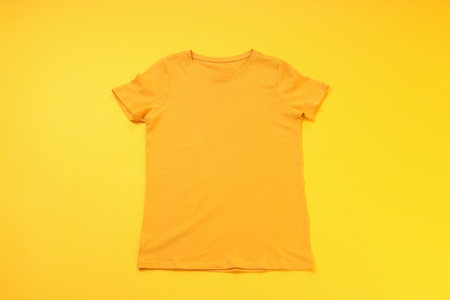 Orange t-shirt with space for print on yellow backgroundの写真素材