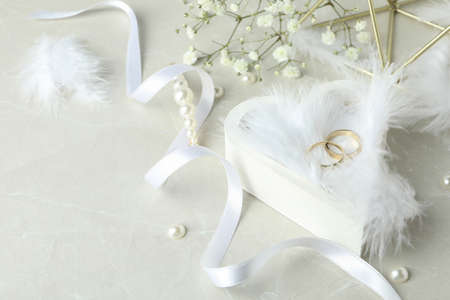 Concept of wedding accessories with wedding rings on white textured backgroundの写真素材