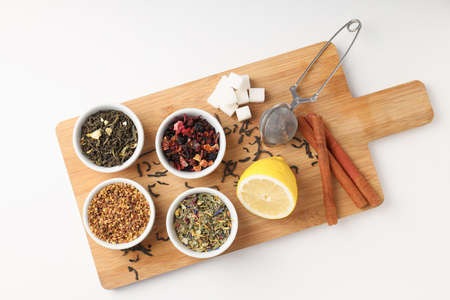Concept of cooking tea with different types of tea on white backgroundの写真素材