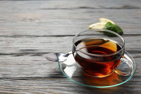 Concept of hot drink with tea on gray wooden backgroundの写真素材