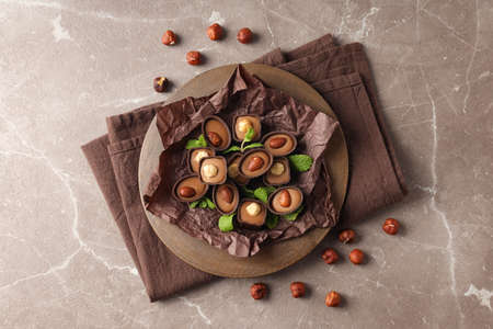 Concept of sweets with chocolate candies on textured background