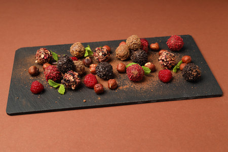 Concept of sweets with chocolate candies on brown backgroundの写真素材