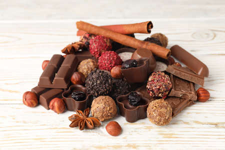 Concept of sweets with chocolate candies on white wooden backgroundの写真素材