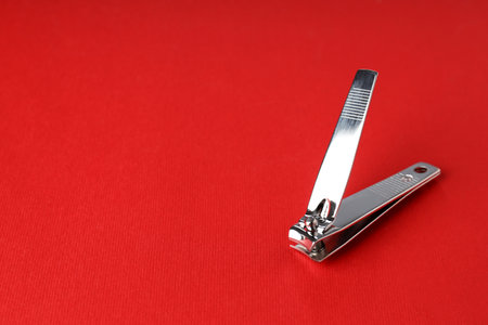 Nail clippers on red background, close upの写真素材