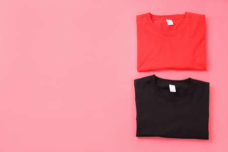Folded black and red t-shirts on pink backgroundの写真素材