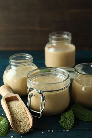 Concept of tasty food with tahini sauce on wooden table