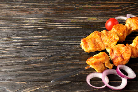 Concept of tasty food with chicken shashlik on dark wooden backgroundの写真素材
