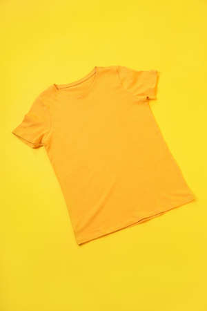 Orange t-shirt with space for print on yellow backgroundの写真素材