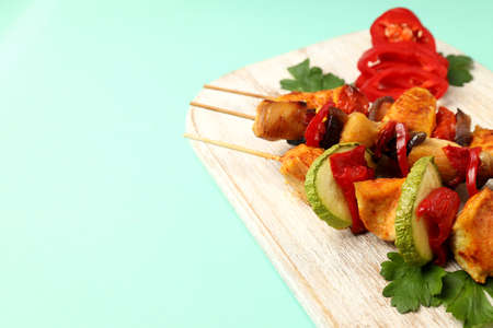 Concept of tasty food with chicken shashlik on mint backgroundの写真素材