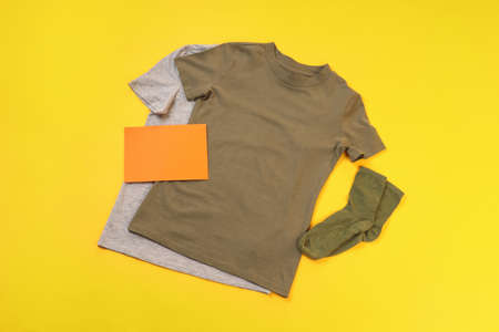 Blank t-shirts, socks and space for text on yellow backgroundの写真素材