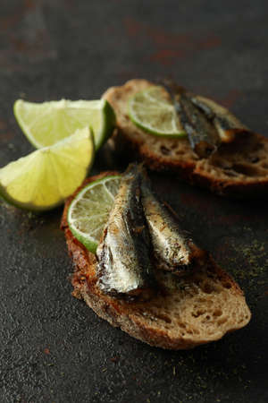 Delicious sandwiches with sprats on textured backgroundの写真素材