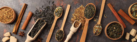 Concept of cooking tea with different types of tea on dark textured backgroundの写真素材