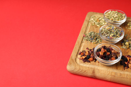 Concept of cooking tea with different types of tea on red backgroundの写真素材