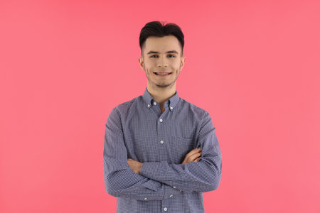 Attractive guy in shirt on pink backgroundの写真素材