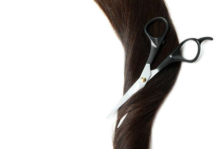 Female hair with scissors on white backgroundの写真素材