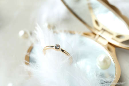 Concept of wedding accessories with wedding rings on white textured background