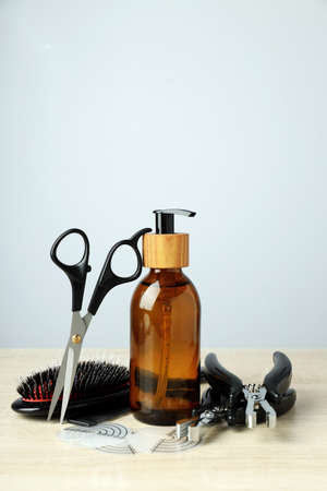 Composition with hair extension accessories on wooden table