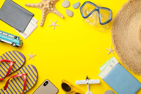 Travel accessories on yellow background, top viewの写真素材