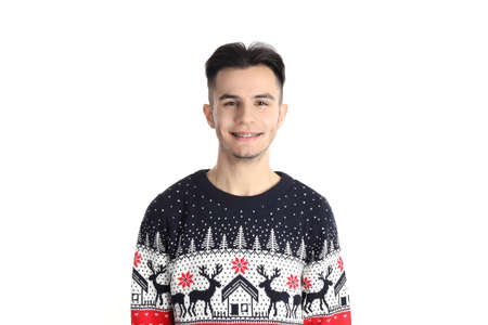 Attractive guy in Christmas sweater on pink backgroundの写真素材