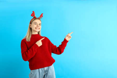 Girl in Christmas clothes on blue backgroundの写真素材