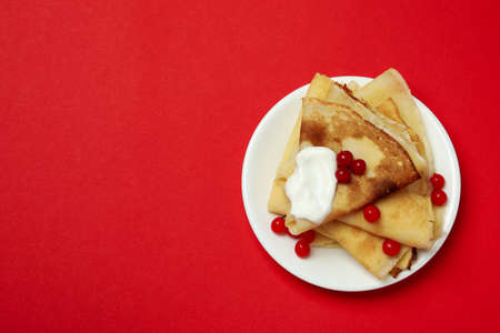 Concept of tasty food with crepes on red backgroundの写真素材