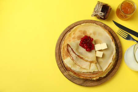 Concept of tasty food with crepes on yellow backgroundの写真素材