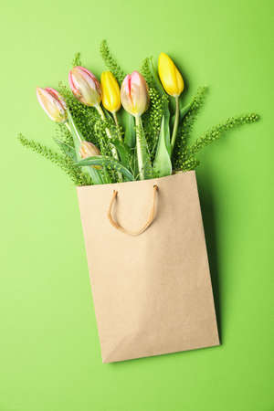 Paper bag with flowers on green backgroundの写真素材