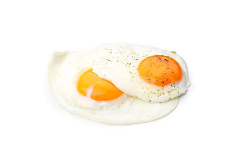 Fried eggs with spices isolated on white background